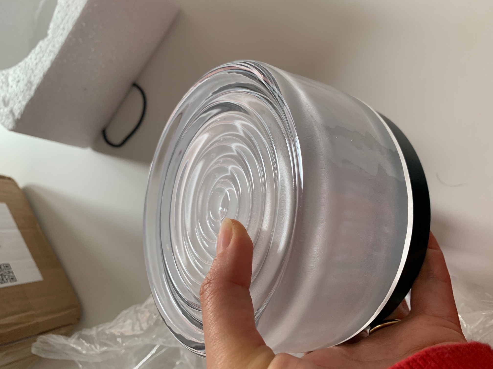 Holding the Ahni dimmable LED wall lamp in hand