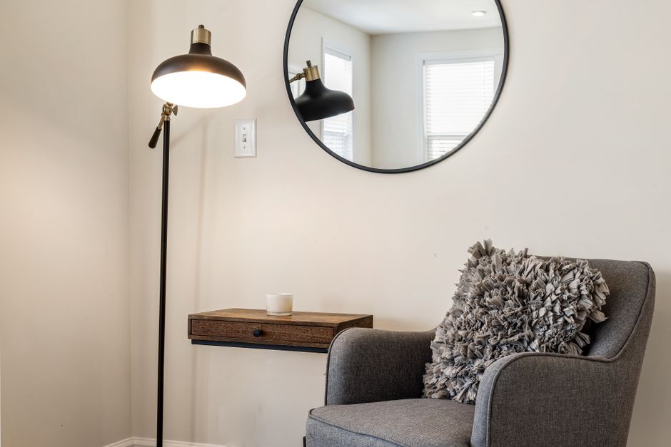 Arc floor lamp in a living room corner casting warm ambient light